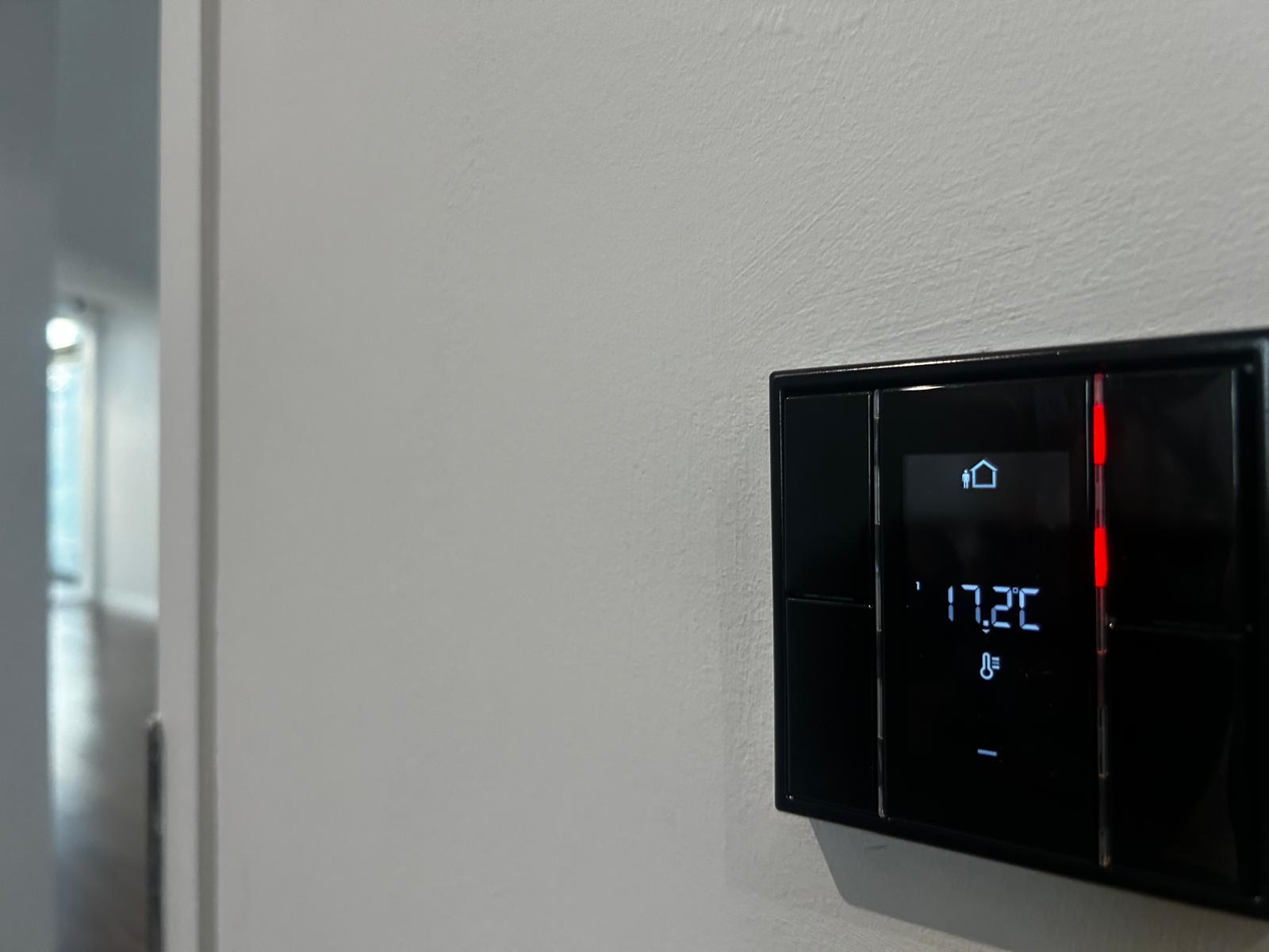 Wall mounted smart home thermostat climate control interface.